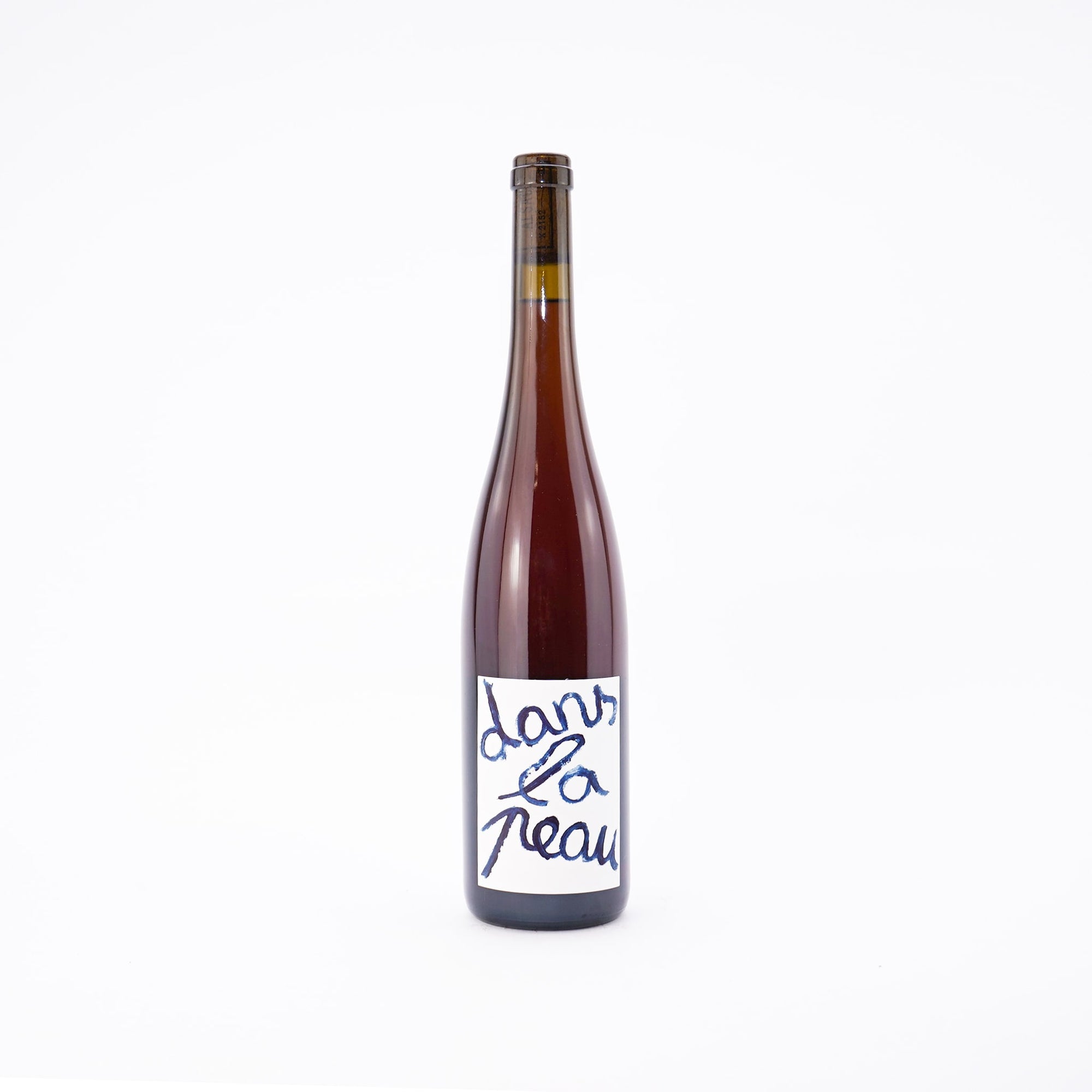 A bottle of orange natural wine cuvee Dans La Peau by Jeux De Vins Alsace France Front View